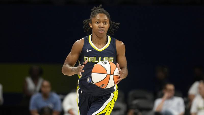 Dallas Wings guard Crystal Dangerfield handles the ball during a WNBA basketball game against...