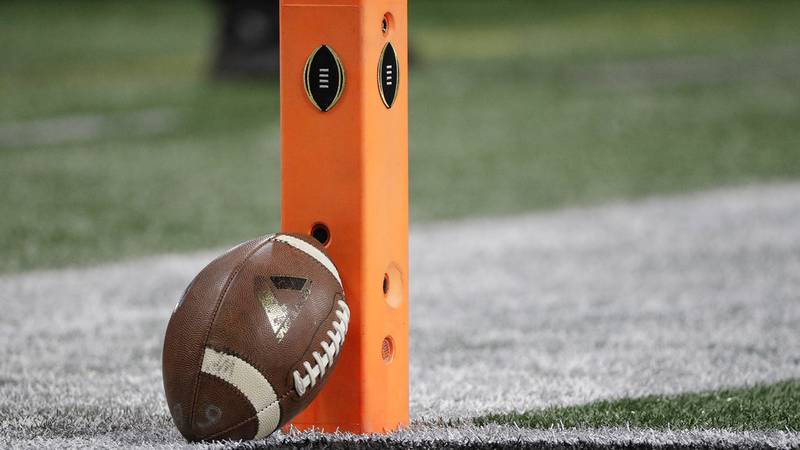 A football rests on a pylon before the NCAA college football playoff championship game between...