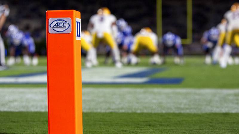 The ACC and Duke logos seen on a pylon at the back of and end zone during an NCAA college...